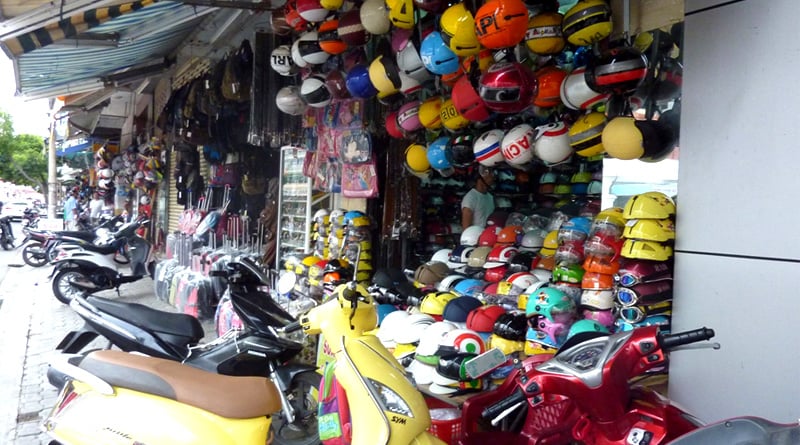 People are taking helmet for rent for getting petrol