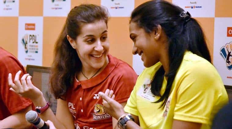 Hyderabad: Ace shuttler P V Sindhu and Spain's Carolina Marin chat at a press conference of the the Premier Badminton League (PBL) in Hyderabad on Friday. PTI Photo(PTI12_30_2016_000214B)