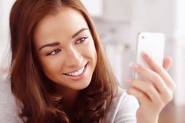 Pretty young woman using mobile phone