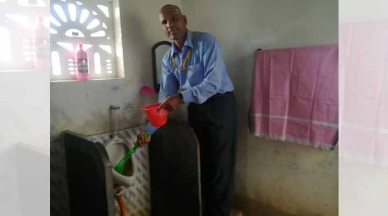 School teacher cleans toilet