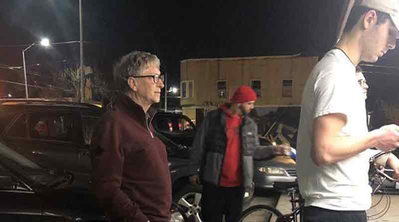 Bill Gates standing in a queue