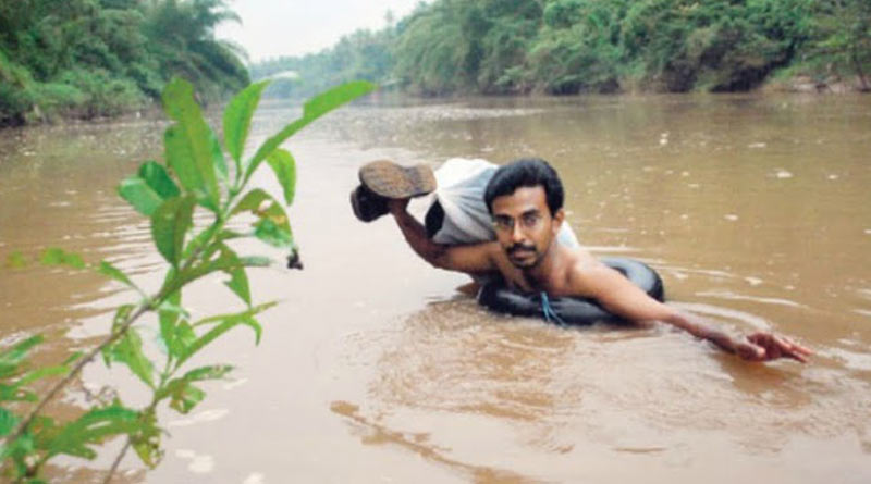 A teacher who lives in Kerala, swims through the river everyday to reach school