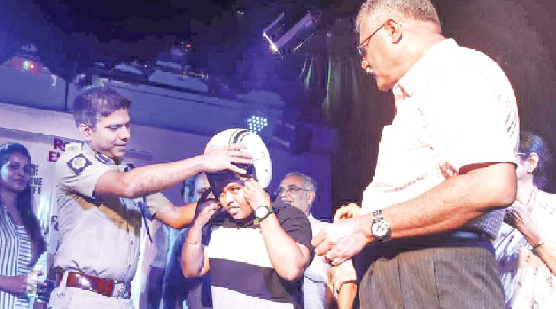 To prevent bike accident Kolkata Police distributes helmet among students