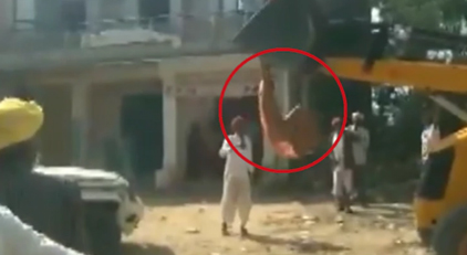 Lady sarpanch climbs on JCB machine to stop demolition
