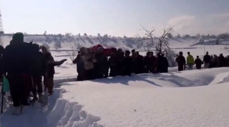 Jawans carrying a pregnant woman through heavy snow
