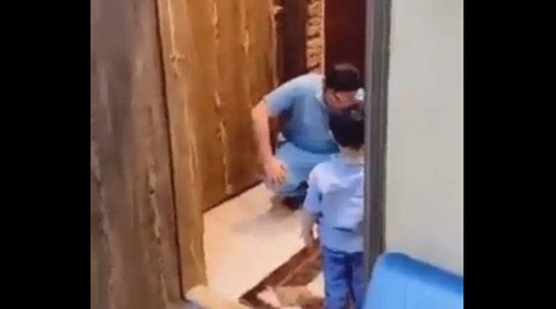 Doctor breaks into tears after stopping son from hugging him