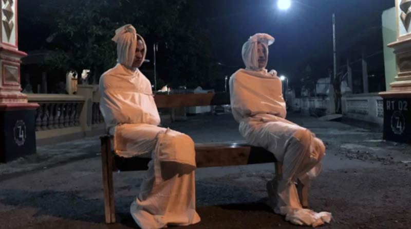 People in Indonesia dress up as ghosts to scare villagers off roads