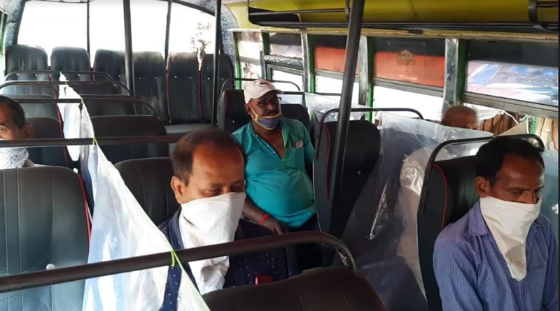 Polythene curtains are hung between the two passengers of the bus