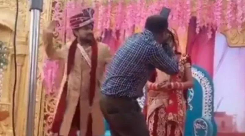 Groom beats photographer for getting too close to bride, she has a literal ROFL reaction | Sangbad Pratidin