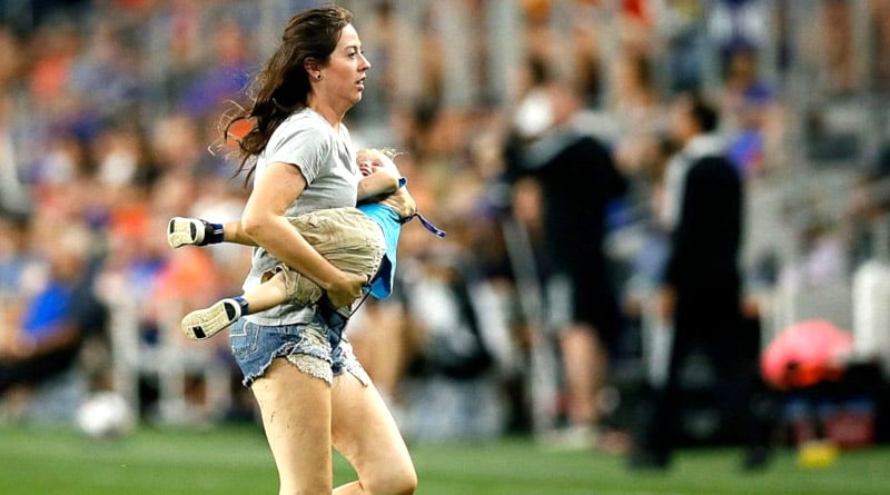 2-year-old child runs into the field during football match, mother chases him | Sangbad Pratidin