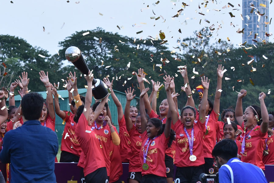 Sports Minister Arup Biswas receives the IWL trophy on behalf of East Bengal