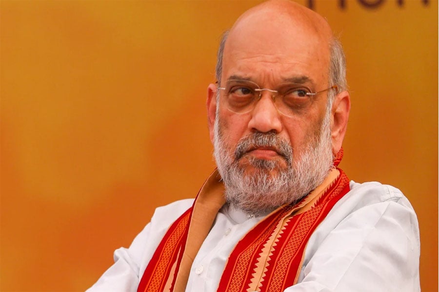 Person who made complaint against Amit Shah is standing next to him on stage