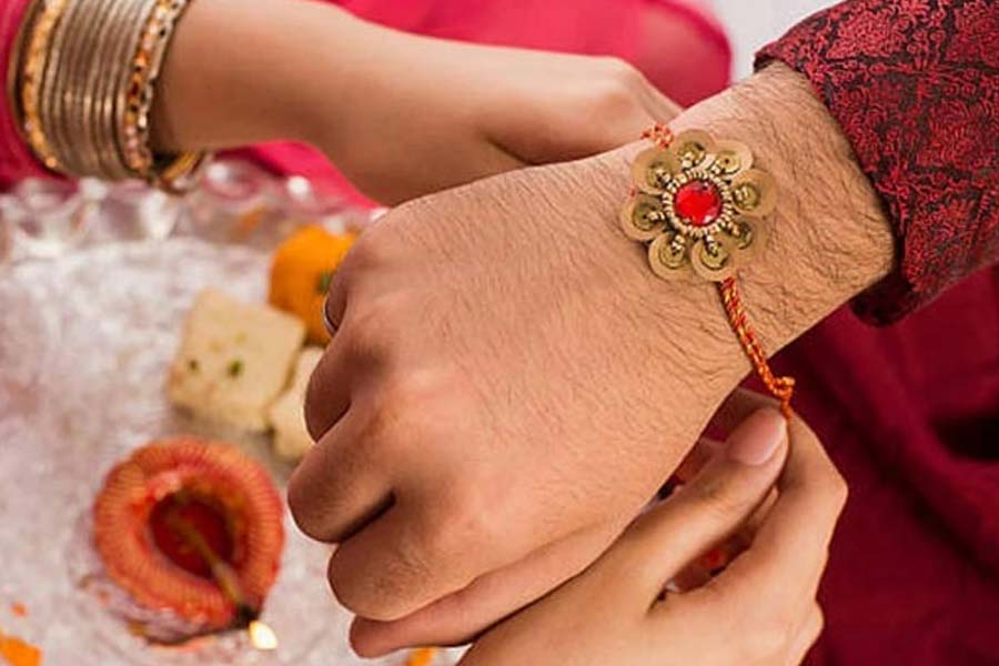 Why do sisters tie three knots on their brothers hands while tying the rakhi on Rakhi Purnima