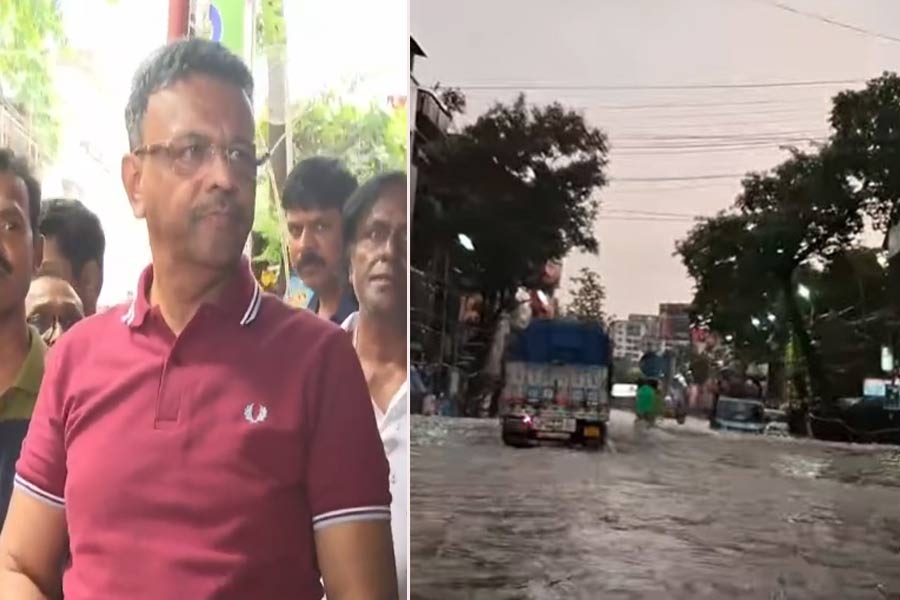 Kolkata Mayor Firhad Hakim cleans waterlogged road